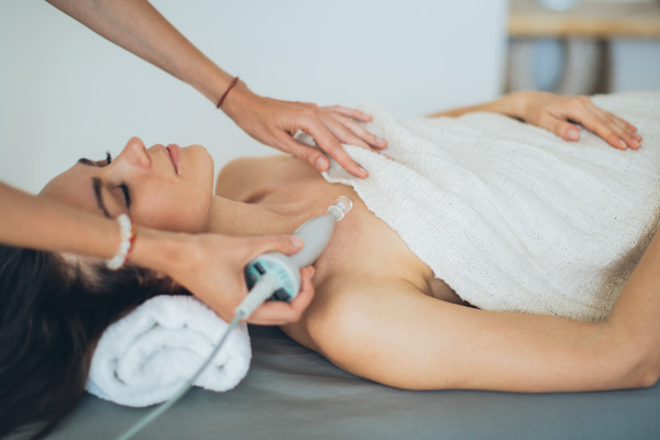 a woman lying down with towel on here body