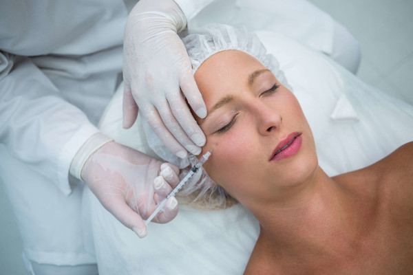 female patient receiving a botox injection on face